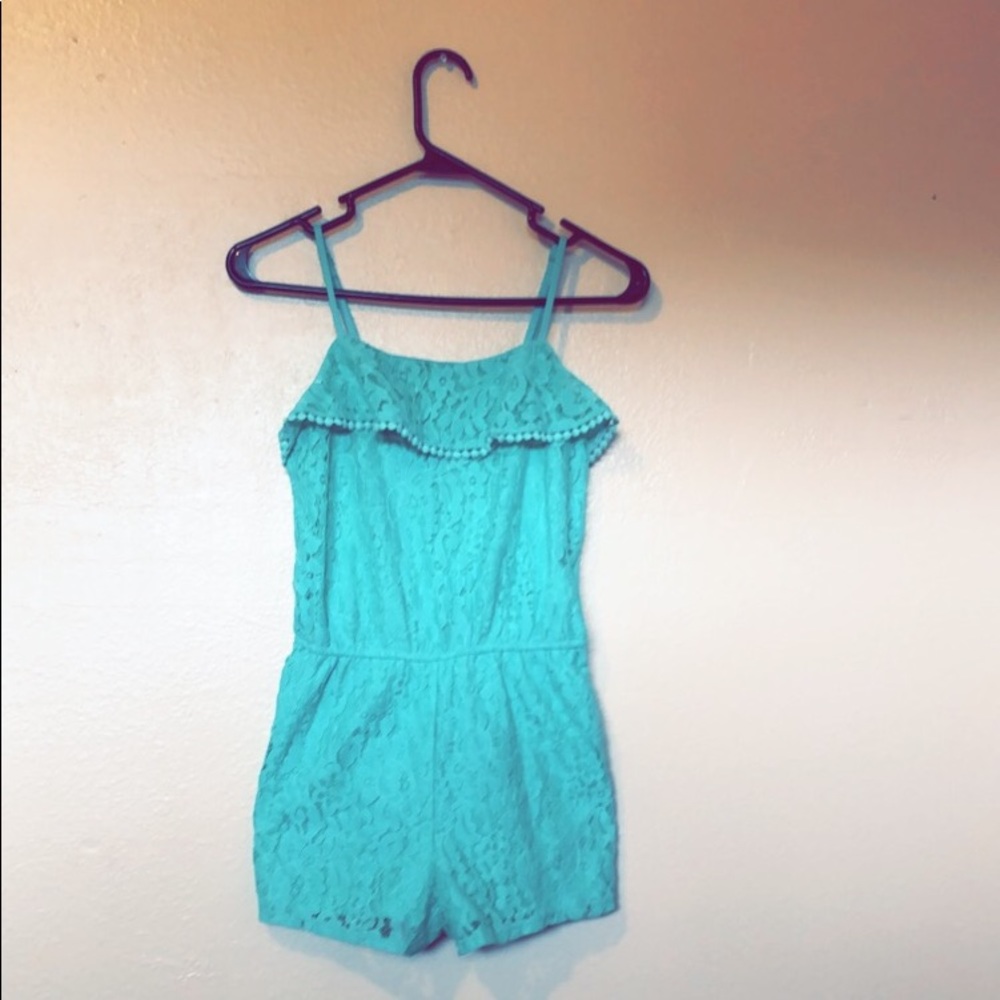 Teal romper with a floral design